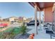 Covered front porch with stone base columns and a view of the front yard and the surrounding neighborhood at 975 Alta St, Lochbuie, CO 80603