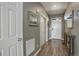 Hallway with wood-look flooring leading to the front door and other rooms at 975 Alta St, Lochbuie, CO 80603