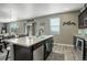 Open kitchen featuring a center island with a dishwasher, sink, and ample storage at 975 Alta St, Lochbuie, CO 80603