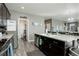 Open kitchen boasts a center island, stainless steel appliances, and pantry access at 975 Alta St, Lochbuie, CO 80603