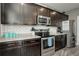Bright kitchen features stainless steel appliances, ample storage, and subway tile backsplash at 975 Alta St, Lochbuie, CO 80603