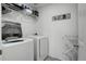 Bright laundry room equipped with modern washer and dryer for convenient chores at 975 Alta St, Lochbuie, CO 80603