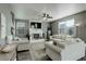 Bright living room featuring a fireplace, large TV, and comfortable seating with lots of natural light at 975 Alta St, Lochbuie, CO 80603
