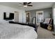 Spacious main bedroom boasts a ceiling fan, television, and en-suite bath at 975 Alta St, Lochbuie, CO 80603