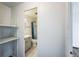Bathroom entrance view featuring vanity, toilet, and shower with white tile surround at 4600 E Asbury Cir # 210, Denver, CO 80222