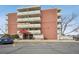 Exterior building view showcasing the entrance, balconies, and the building's brick facade at 4600 E Asbury Cir # 210, Denver, CO 80222