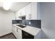 Updated kitchen with white cabinets, quartz countertops, and sleek black appliances at 4600 E Asbury Cir # 210, Denver, CO 80222