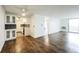 Open living room featuring hardwood floors, ceiling fan, and modern kitchen at 4600 E Asbury Cir # 210, Denver, CO 80222