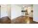 Open living room and kitchen featuring hardwood floors and white cabinets at 4600 E Asbury Cir # 210, Denver, CO 80222