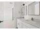 Bright white bathroom featuring dual sinks, marble countertops, and modern fixtures at 39441 Stockton Cir, Elizabeth, CO 80107