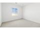 Bright bedroom featuring neutral walls and carpet with a window view at 39441 Stockton Cir, Elizabeth, CO 80107