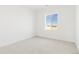 Bright bedroom showcasing neutral walls and carpet with a view from the window at 39441 Stockton Cir, Elizabeth, CO 80107