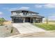 Contemporary home featuring a spacious driveway, multiple garages, and manicured lawn at 39441 Stockton Cir, Elizabeth, CO 80107