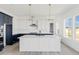 Bright kitchen features white cabinets, gray countertops, stainless steel appliances and modern pendant lights at 39441 Stockton Cir, Elizabeth, CO 80107