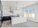 Bright kitchen features white cabinets, gray countertops, and stainless steel appliances at 39441 Stockton Cir, Elizabeth, CO 80107