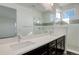 Modern bathroom featuring dual sinks, quartz countertops, and a glass-enclosed shower at 11063 Shining Star Cir, Parker, CO 80134