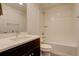 Bathroom features a vanity with dark wood cabinetry and shower and tub combo at 11063 Shining Star Cir, Parker, CO 80134