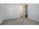 Bright bedroom with neutral carpet, white walls, closet, and view into the hallway at 11063 Shining Star Cir, Parker, CO 80134