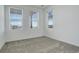 Empty bedroom with light-colored carpet and large windows that provide an ample amount of natural light at 11063 Shining Star Cir, Parker, CO 80134