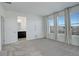 Bright, carpeted bedroom with large windows, neutral walls, and an en-suite bathroom at 11063 Shining Star Cir, Parker, CO 80134