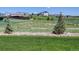 Idyllic community landscape featuring mature trees and lush greenery; houses on the horizon at 11063 Shining Star Cir, Parker, CO 80134