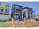 Charming exterior of a three-story home with a blue facade, brick accents, and a fenced front yard at 11063 Shining Star Cir, Parker, CO 80134