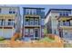 Charming exterior of a three-story home with a blue facade, brick accents, and a fenced front yard at 11063 Shining Star Cir, Parker, CO 80134