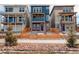 Charming two-story home with a blue facade, brick accents, and a lovely wooden fence at 11063 Shining Star Cir, Parker, CO 80134