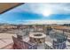 Outdoor patio with fire pit and comfortable seating overlooking a neighborhood landscape at 11063 Shining Star Cir, Parker, CO 80134