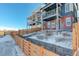 Stylish two-story home featuring a brick facade, dual balconies, steps, and snow-covered landscape at 11063 Shining Star Cir, Parker, CO 80134