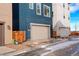 A two-car garage in a modern home with a blue facade at 11063 Shining Star Cir, Parker, CO 80134