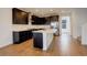Modern kitchen with dark cabinetry, white countertops, and a large center island at 11063 Shining Star Cir, Parker, CO 80134