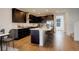 Modern kitchen with dark cabinetry, white countertops, and a spacious island with seating at 11063 Shining Star Cir, Parker, CO 80134