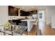 Modern kitchen with dark cabinetry, stainless steel appliances, and a large island with barstool seating at 11063 Shining Star Cir, Parker, CO 80134