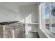 Well-lit laundry room with new washer and dryer, window, countertop, and convenient wire shelving at 11063 Shining Star Cir, Parker, CO 80134