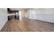 Open-concept living room with hardwood floors and a modern kitchen in the background at 11063 Shining Star Cir, Parker, CO 80134
