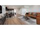 Open-concept living room with dining area, hardwood floors, and a modern kitchen view at 11063 Shining Star Cir, Parker, CO 80134