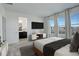 Bright bedroom with large windows, a modern TV, and an ensuite bathroom at 11063 Shining Star Cir, Parker, CO 80134