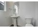 This modern powder room features a pedestal sink, toilet, and a large mirror at 11063 Shining Star Cir, Parker, CO 80134