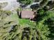 An aerial view of this home nestled among the trees, with a back deck and hot tub at 384 Blue Ridge Rd, Breckenridge, CO 80424