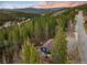 Scenic aerial view of a home nestled among lush trees and a winding mountain road at 384 Blue Ridge Rd, Breckenridge, CO 80424