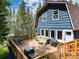 A spacious back deck with furniture, grill, and a mountain view provides outdoor living at 384 Blue Ridge Rd, Breckenridge, CO 80424