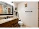 Bathroom with granite counters, dark wood cabinets and a tile shower behind a glass door at 384 Blue Ridge Rd, Breckenridge, CO 80424