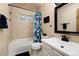 Bright bathroom featuring tiled shower and tub with single sink vanity and patterned shower curtain at 384 Blue Ridge Rd, Breckenridge, CO 80424