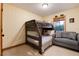Bedroom with bunkbeds, seating area and a window with wood accents at 384 Blue Ridge Rd, Breckenridge, CO 80424