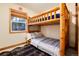 Rustic bedroom featuring a charming log bunk bed and a cozy, inviting atmosphere at 384 Blue Ridge Rd, Breckenridge, CO 80424