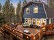 Exterior view of a two-story home featuring a large outdoor deck with plenty of seating at 384 Blue Ridge Rd, Breckenridge, CO 80424