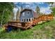 Exterior view of a home featuring a beautiful deck with stairway entry and a hillside lawn at 384 Blue Ridge Rd, Breckenridge, CO 80424