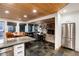 Open concept kitchen with stone floors flowing into the dining area and living room with a stone fireplace at 384 Blue Ridge Rd, Breckenridge, CO 80424