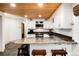Kitchen with white cabinets, stainless steel appliances, granite counters and breakfast bar with seating at 384 Blue Ridge Rd, Breckenridge, CO 80424